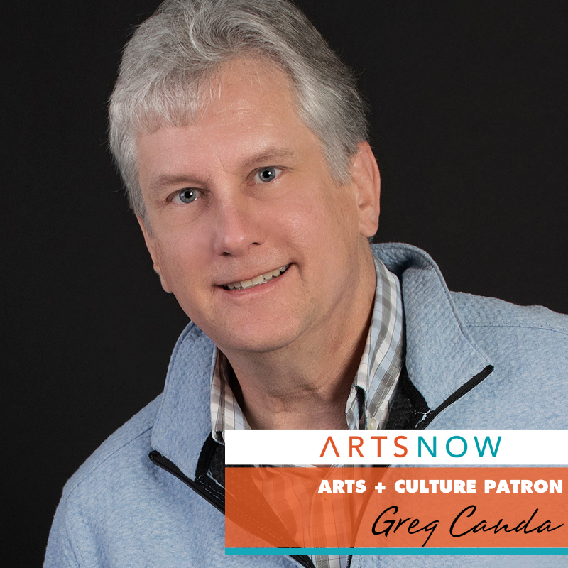 Photo of man in front of black background wearing a blue, white, and brown plaid top under a light blue jacket. In the corner is a white, orange, and yellow box. Inside the white box, the next says ArtsNow in red and blue text. The orange box says "Arts + Culture Patron" in white text and "Greg Canda" in black text.